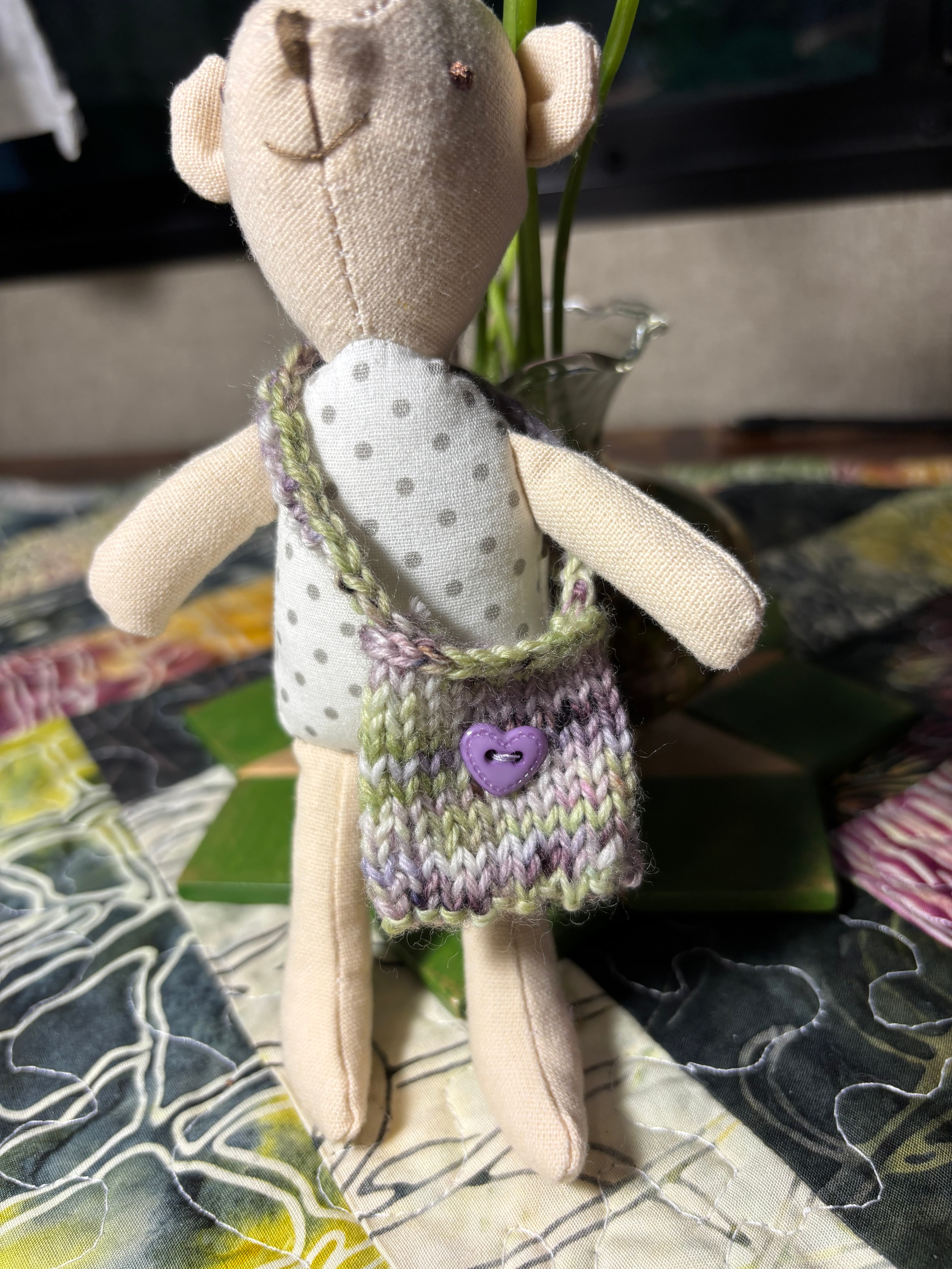 Miniature hand-knit and crochet doll handbags with I-cord handles.